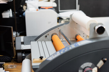 paper roll inside of professional print plotter in copy center.