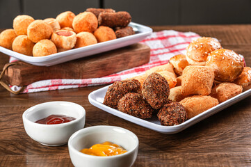 Various brazilian snacks deep fried. (Coxinha, kibe, empadinha e risolis).