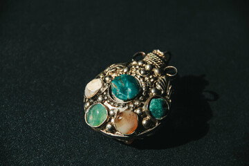 Beautiful pendant with large stones on a dark background