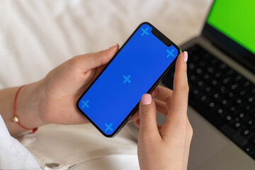 Close up teenage hands using smartphone green blue screen Chroma Key.