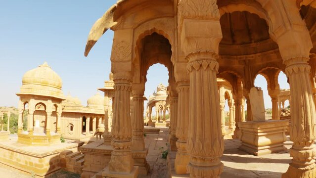 4K Wide angle shot of dome shaped cenotaphs of old Kings at Bada bagh in Jaisalmer, Rajasthan, India. Old tombs of the ancient kings in Jaisalmer made out of sand stone. Bada bagh during sunny day .