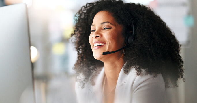 Happy female customer service agent smiling while working in a call centre, talking to a client with a headset. A helpful saleswoman assisting customers with purchase orders and questions online