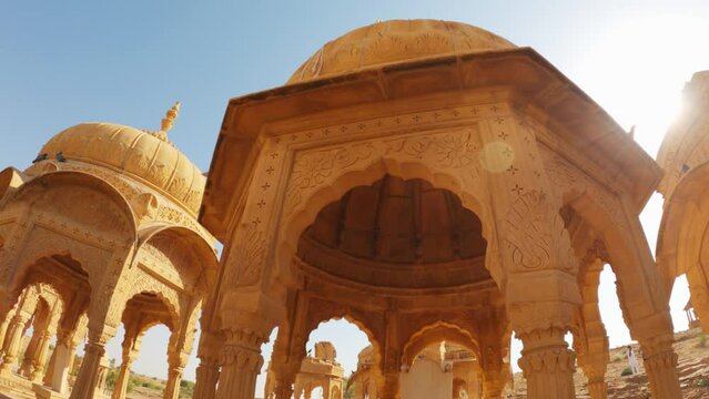 4K Wide angle shot of dome shaped cenotaphs of old Kings at Bada bagh in Jaisalmer, Rajasthan, India. Old tombs of the ancient kings in Jaisalmer made out of sand stone. Bada bagh during sunny day .