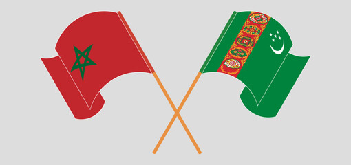 Crossed and waving flags of Morocco and Turkmenistan