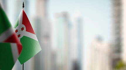 Small flags of the Burundi on an abstract blurry background