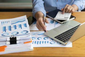 Businessman working with business report papers on office desk, financial chart analysis with...