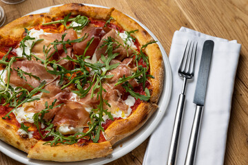 delicious italian pizza on a wooden table
