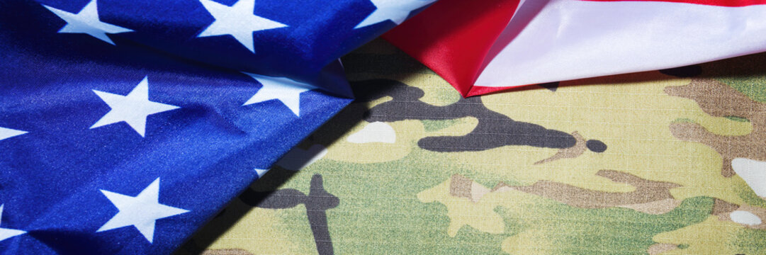 American flag and camouflage background. Panoramic banner