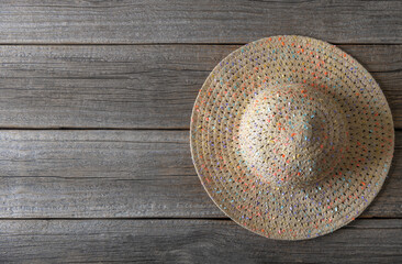 The straw hat lies on wooden boards. There is space for text.