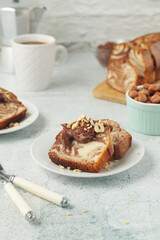 A piece of marble biscuit with chocolate cream and nuts