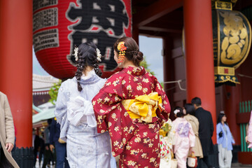 Fototapeta na wymiar Young girl wearing Japanese kimono standing in Kyoto, Japan. Kimono is a Japanese traditional garment. The word 