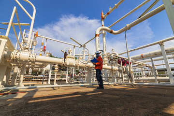 Fototapeta premium Male worker inspection at valve of visual check record pipeline oil and gas