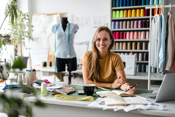 Young fashion designer at her workplace
