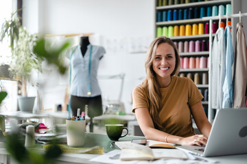 Young fashion designer at her workplace
