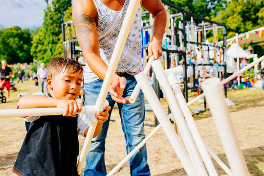 Father and son installing rack during festival