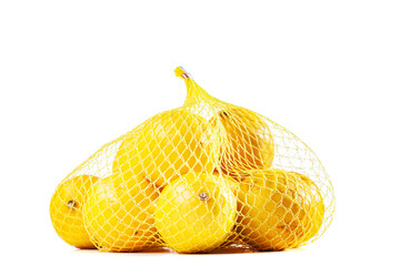 group of ripe lemons in a mesh bag against white background