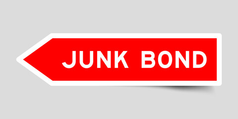 Red color arrow shape sticker label with word junk bond on gray background