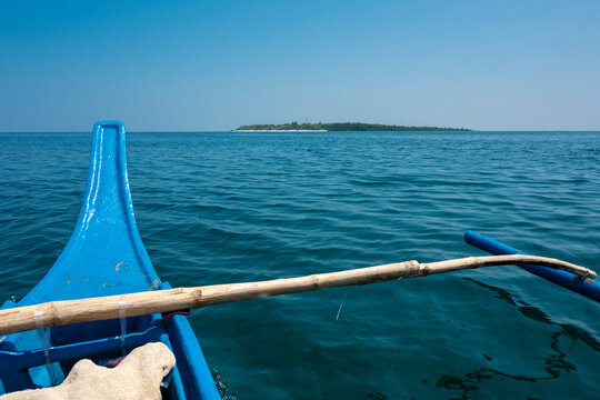 A small pumpboat or outrigger approaching the island of Nogas off the province of Antique on the island of Panay.
