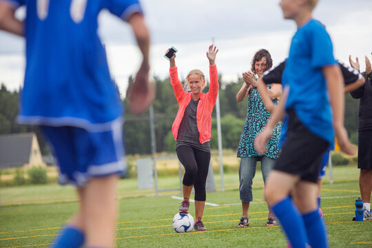 Mothers supporting sons (10-11) during soccer practice