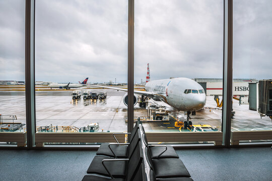 London, United Kingdom - December 25, 2017 : Airplane of American Airlines being serviced at the London Heathrow airport, as seen from the waiting hall.