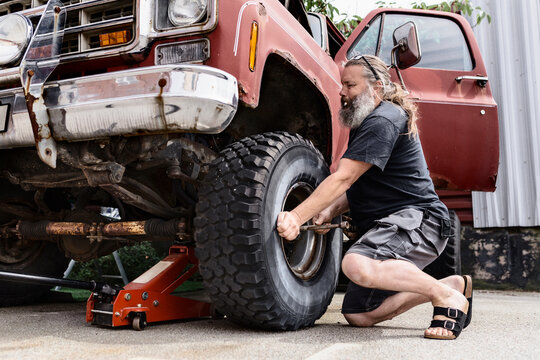 Mature man repairing old car