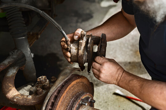 Mature man repairing car