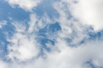 Air clouds on the blue sky. Light blue background in the air. Abstract style with place for text for design