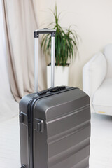 Gray beautiful suitcase for tourist trips. High-quality gray suitcase for things.