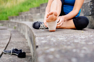Woman wrapping foot in bandage