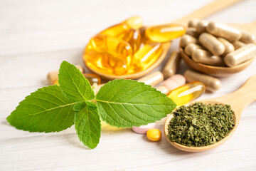 Alternative medicine herbal organic capsule with vitamin E omega 3 fish oil, mineral, drug with herbs leaf natural supplements for healthy good life.