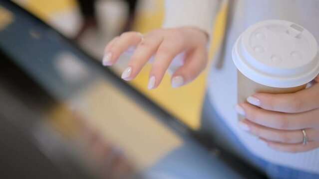 Interactive map of the shopping center, floor plan. female hands move across the screen, moving the plan. touch screen