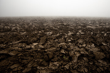 Fertile, dark soil, field after plowing. Getting ready for the next growing season being turned by plowing