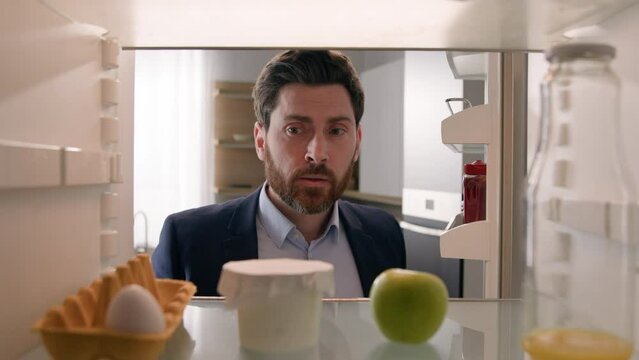 Point of view POV inside empty refrigerator Caucasian sad hungry businessman upset man open fridge with one egg empty bottle of juice searching snack take apple fruit diet need products food delivery