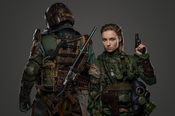 Photo of isolated on grey two female and male soldiers posing back to back.