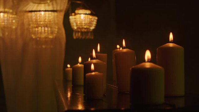 In the darkness, a witch performs a mystic rite with black candles and voodoo magic. A close-up of the piano accentuates the mysticism and paganism of the ritual.