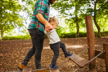 Father with daughter (2-3) in playground