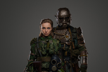 Shot of military woman and man in setting of post apocalypse.
