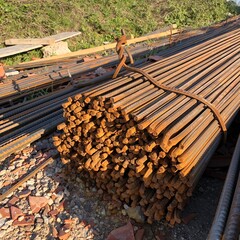 Closeup of reinforcement steel bars bundle tied by a deformed bar on the ground in the construction...