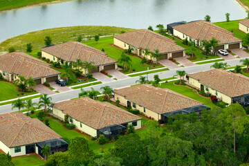 Fototapeta na wymiar Aerial view of tightly packed homes in Florida closed living clubs. Family houses as example of real estate development in american suburbs