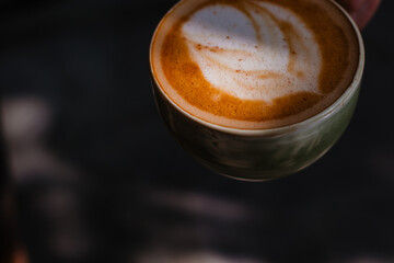 Fragrant cappuccino with beautiful foam close-up Coffee banner with space for text. Coffee for breakfast on a dark background