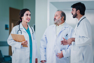 Professional Medical Doctors and team discussing in clinic hall, healthcare professionals having discussion in hospital corridor.