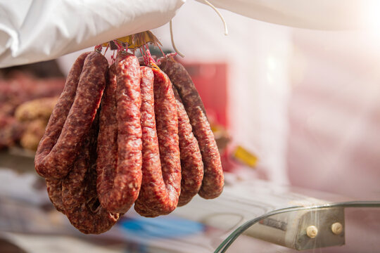 Fresh pork sausage rings lie on the counter of the meat market. Smoked meat products handmade. Buying food from meat.