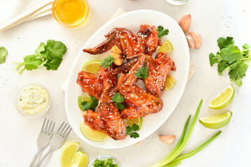 Sticky honey-soy chicken wings on plate
