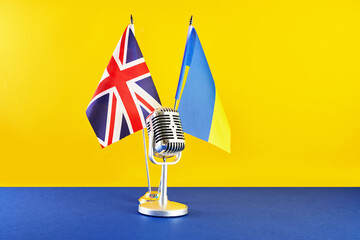 Microphone on a background of a blurry flags Ukraine and Great Britain. European Song Contest...