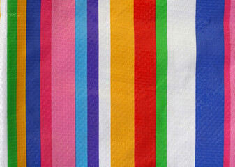 Plastic texture with colorful stripes for making fashion bags or fabric materials.