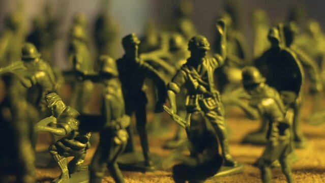 Ranks of military armed plastic toy soldiers in combat detachments. Violence war resistance and peace without armored invasion
