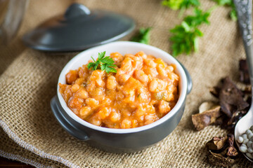 beans stewed with vegetables and spices, in a bowl .