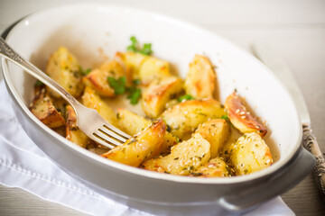 potatoes baked with sesame seeds, herbs and spices in the oven