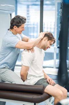 Physical therapist working with patients neck