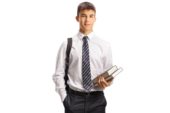 Male teen student in a school uniform holding books